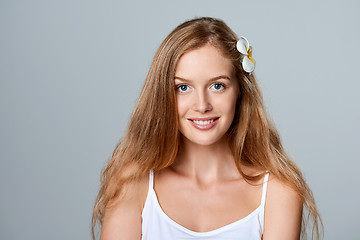 Image showing Beautiful young woman with flower in hair