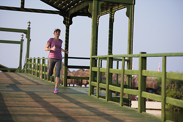 Image showing sporty woman jogging