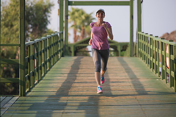 Image showing sporty woman jogging