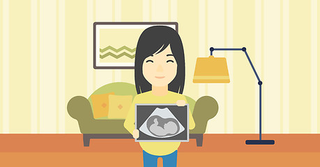 Image showing Pregnant woman with ultrasound image.