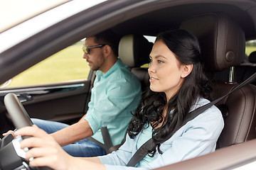 Image showing happy man and woman driving in car