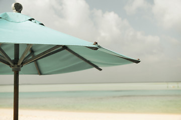 Image showing parasol over blue sky and beach