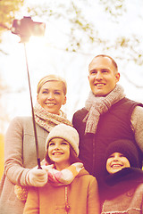 Image showing happy family with smartphone and monopod in park