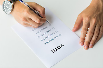 Image showing close up of hands with vote or ballot on election