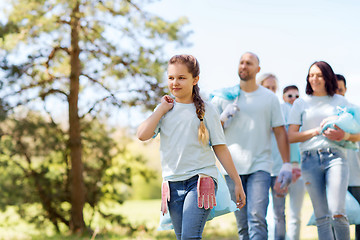 Image showing group of volunteers with garbage bags in park