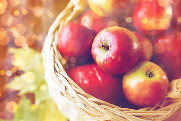 Image showing close up of basket with apples on wooden table