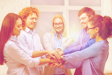 Image showing team with hands on top of each other in office