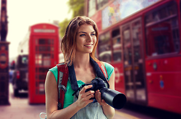 Image showing woman with backpack and camera over london city