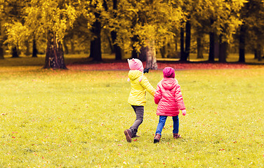 Image showing happy little girls running outdoors