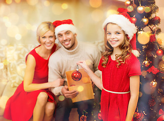 Image showing smiling family decorating christmas tree