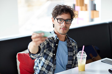 Image showing happy man with cash money paying at cafe