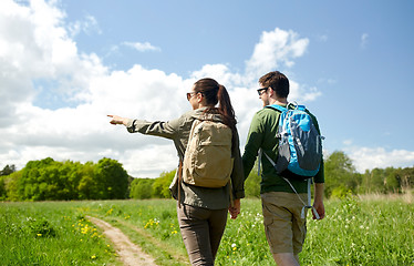 Image showing happy couple with backpacks hiking outdoors