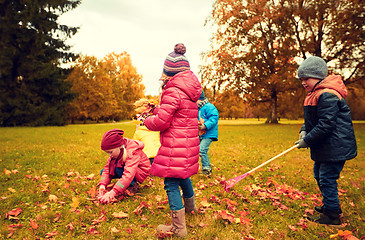 Image showing group of children collecting leaves in autumn park