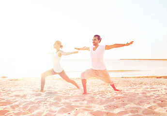 Image showing couple making yoga exercises outdoors