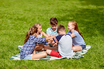 Image showing group of happy kids putting hands together