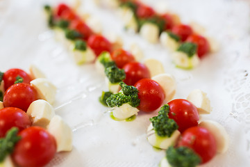 Image showing close up of mozzarella and cherry tomato canape