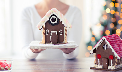 Image showing close up of woman showing gingerbread house