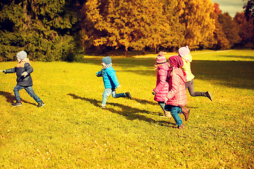 Image showing group of happy little kids running outdoors