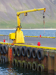 Image showing Fishing crane in small seaside Iceland town harbor