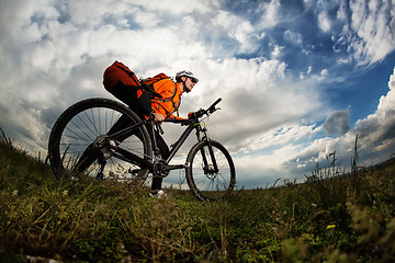 Image showing Young man travel by bicycle on rural road