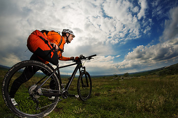 Image showing Young man travel by bicycle on rural road