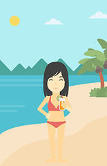 Image showing Woman with cocktail on the beach.