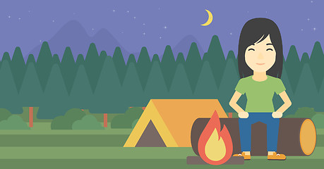 Image showing Woman sitting on log in the camping.