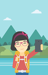 Image showing Woman with backpack making selfie.