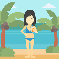 Image showing Woman with cocktail on the beach.