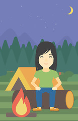 Image showing Woman sitting on log in the camping.