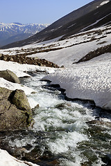 Image showing Mountain river with snow bridges in spring sun day