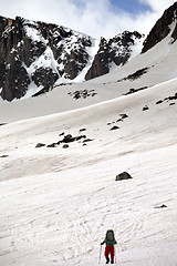 Image showing Hiker in snowy mountain at nice spring day