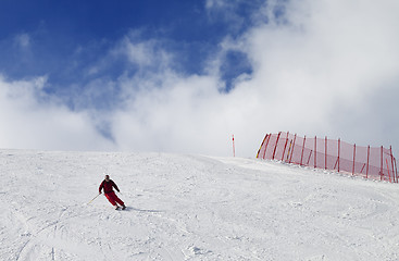 Image showing Skier on ski slope at nice sun day