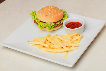 Image showing classic burger with French fries on the table in a cafe