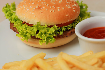 Image showing classic burger with French fries on the table in a cafe