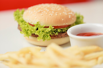 Image showing classic burger with French fries on the table in a cafe
