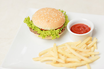 Image showing classic burger with French fries on the table in a cafe