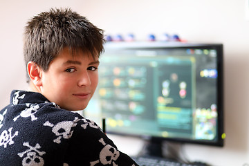 Image showing Boy using computer at home, playing game