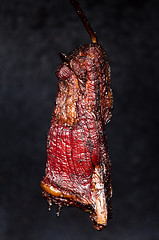 Image showing Smoking pork neck in home smokehouse