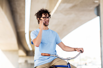 Image showing man with smartphone and fixed gear bike on street