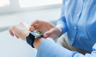 Image showing close up of hands with web page on smart watch