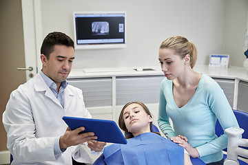 Image showing dentist showing tablet pc to girl and her mother