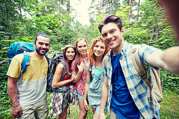 Image showing friends with backpack taking selfie in wood