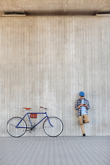 Image showing man with smartphone, earphones and bicycle