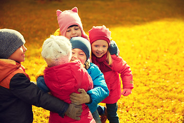 Image showing group of happy children hugging in autumn park