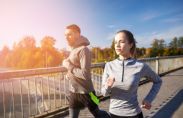 Image showing happy couple running outdoors