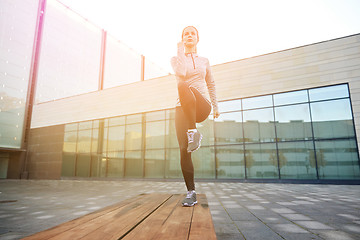 Image showing woman making step exercise on city street bench