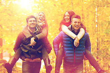 Image showing smiling friends having fun in autumn park