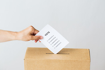 Image showing man putting his vote into ballot box on election