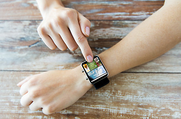 Image showing close up of female hands with news on smart watch